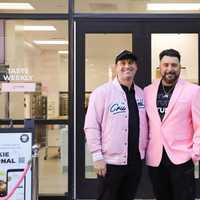 <p>Store owners Dennis Sosa and Richard Howell in front of Hudson Crumbl, wearing the shop's signature pink colors.</p>