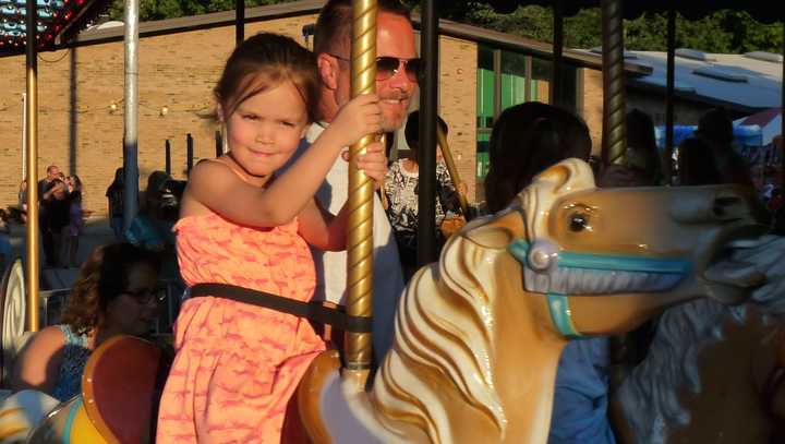 Riding the carousel at the annual Waldwick Lion&#x27;s Carnival.