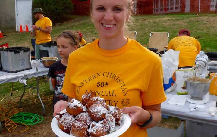 Charissa Scarpa, of Midland Park, serving ollie bollen at the 50th Annual ECCR Country Fair, one of the few places to find the Dutch treat. 