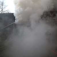 <p>The fire at a home on Cross Highway on Monday morning produces a lot of smoke.</p>