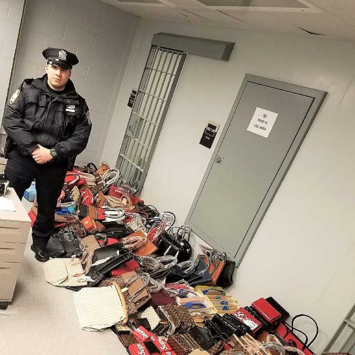 Port Authority Police Officer Christopher Roncancio and the knockoff haul.