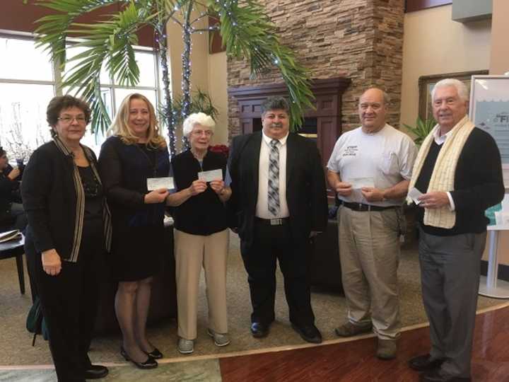 PHC Medical Staff President Dr. Michael Nesheiwat, center, with representatives from Putnam food pantries.