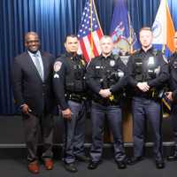 <p>Officers&nbsp;Niall Nerney and Christopher Duffy (center) are being nominated for lifesaving awards for pulling a man out of a burning car.&nbsp;</p>