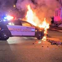 <p>Paterson police car in flames.</p>