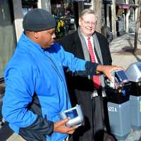 <p>Mayor David Martin and Bureau Chief for Transportation Jim Travers watch as the final meter is installed on Bedford Street in Stamford on Wednesday.</p>