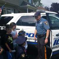 <p>Officer Stanton lets the partygoers check out his squad car</p>