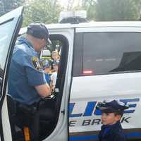 <p>Officer Stanton shows Andrew his police vehicle</p>