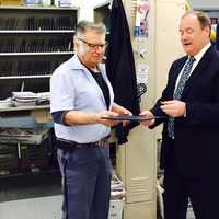 <p>USPS Northeast Area Vice President Edward Phelan presents Franklin Lakes Letter Carrier Paul Dargenzio with his 50 year service pin and congratulatory letter from Postmaster General Megan Brennan.</p>