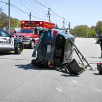 <p>First responders work to free a 73-year-old driver from a Subaru that flipped onto its side on Route 3A Wednesday afternoon, May 10</p>