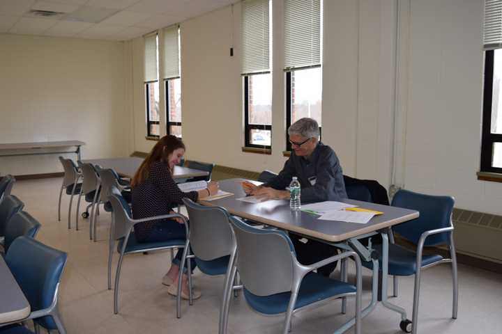 Rippowam Sisqua student Olivia Grubb works on a short story about the rise of the Third Reich with mystery writer Alan Beechey at the Young Authors Master Class at Putnam Northern Westchester BOCES on Dec. 6.