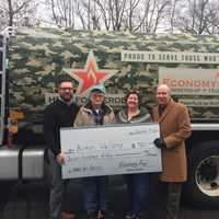 <p>From left, Mike Gill of Economy Fuel, recipient Burton Wellons, Wellons&#x27; daughter Robin Friend and Greater Valley Chamber President Bill Purcell hold Wellons&#x27; check.</p>