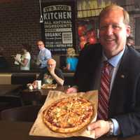 <p>Clarkstown Supervisor George Hoehmann with his pizza at PizzaRev.</p>