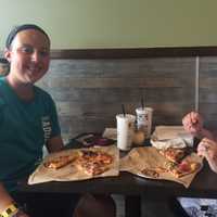 <p>Sloane and Larayne Peterson enjoy their pies at PizzaRev.</p>