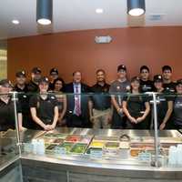 <p>PizzaRev owner Satyen Shah (middle) with Clarkstown Supervisor George Hoehmann and the PizzaRev staff.</p>