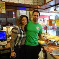 <p>Adisa Feratovic, left, helps her fiancé, Gaetano Buttitta, operate Pizza Mania in Garfield.</p>