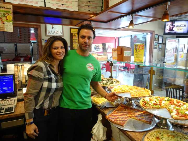 Adisa Feratovic, left, helps her fiancé, Gaetano Buttitta, right, run Pizza Mania in Garfield.