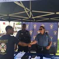 <p>A Ramapo police officer greets a member of the public during the department&#x27;s recruitment drive in Spring Valley.</p>