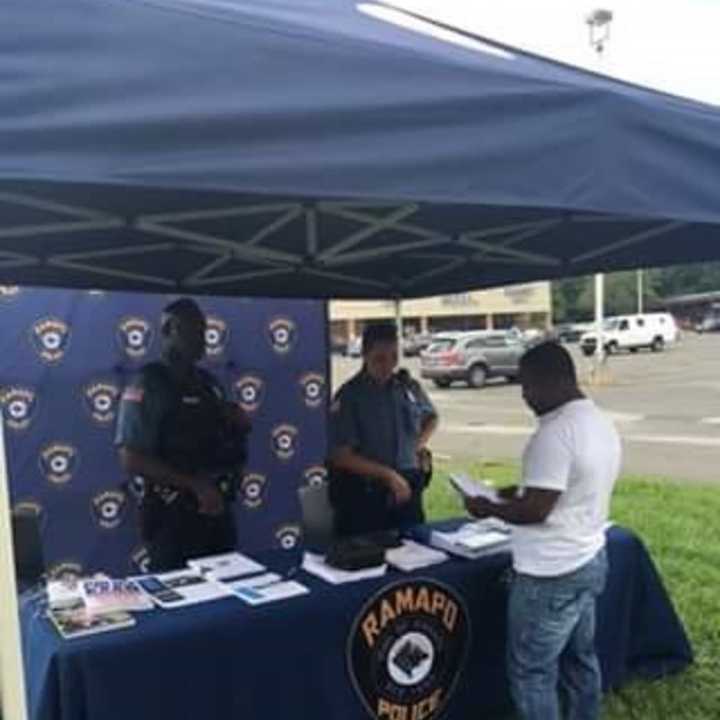 Members of the Ramapo Police Department reach out to the public at a recruitment drive in Spring Valley Saturday. Officers shared personal experiences and handed out information about the upcoming police exam.