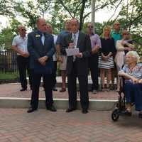 <p>Mayor Thomas Calabrese addresses the crowd. He is joined by Bergen County Clerk John Hogan.</p>