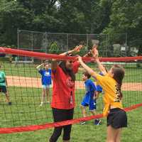 <p>Students give a double high-five during a field day at Riverside School.</p>