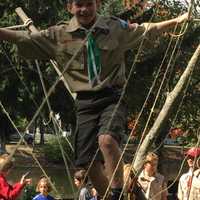 <p>A happy Scout traverses the rope bridge.</p>