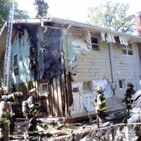 <p>The flames extended to the rear of a neighboring home on Birk Street in Saddle Brook.</p>