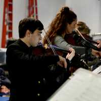 <p>St. John’s Prep senior Gabriel Klein accompanies faculty during a hymnal at a prayer service for sixth-grade student Sebastian Robinson on Thursday evening, Feb. 9</p>