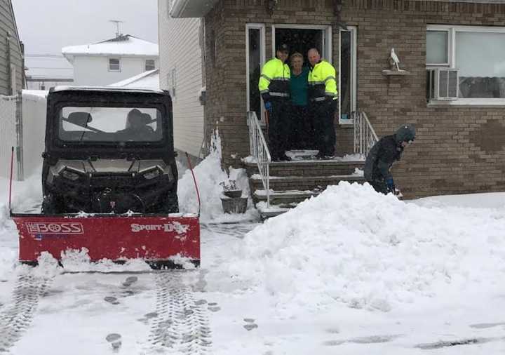 Andrew Ralicki, 15, shovels snow in Saddle Brook for a senior citizen. The senior is flanked by Saddle Brook Police Chief Robert Kugler and Mayor Robert White.