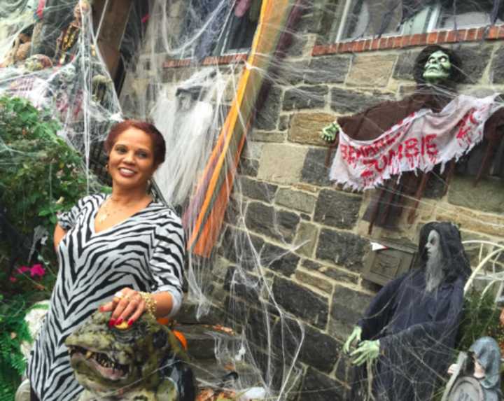 Maria Bruno stands by her St. Roch Avenue home in Greenwich that she has covered in Halloween decorations.