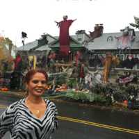 <p>Maria Bruno stands in front of her St. Roch Avenue home in Greenwich that she has covered in Halloween decorations.</p>