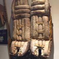 <p>Old goalie pads hang on the wall at the WESCO Sports Center.</p>