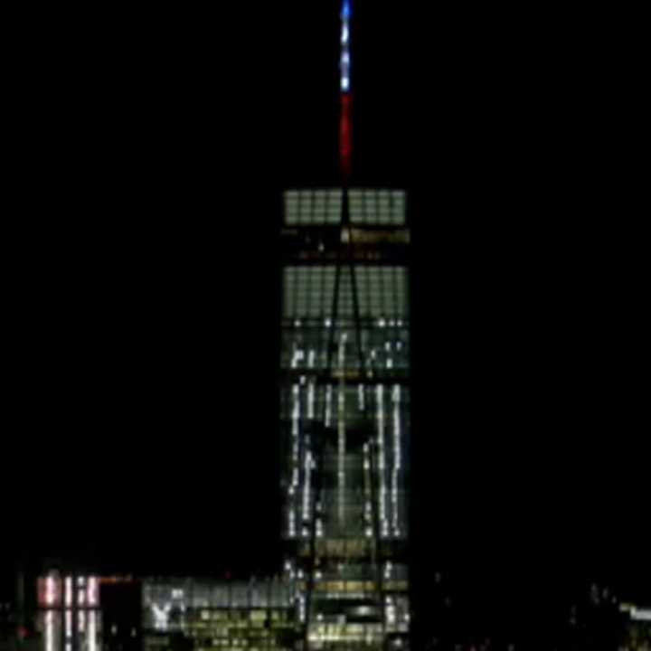 One World Trade Center shows support for France by lighting up in blue, white and red Friday hours after the apparent coordinated terrorist attacks.