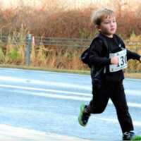 <p>A young boy runs in Sunday&#x27;s race at the Danbury Fair Mall. </p>