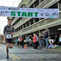 <p>Will Bordash of Ridgefield strides across the finish line to win the Mima&#x27;s Meatball Mile for MSA Sunday in Danbury. </p>