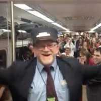 <p>Metro-North conductor Bob McDonough tries his hand at musical conducting as the Yale Glee Club rides his train last week.</p>