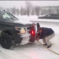 <p>Gov. Andrew Cuomo assists a stranded motorist on the Cross Island Parkway in Nassau County early Saturday afternoon before the travel ban went into effect.</p>