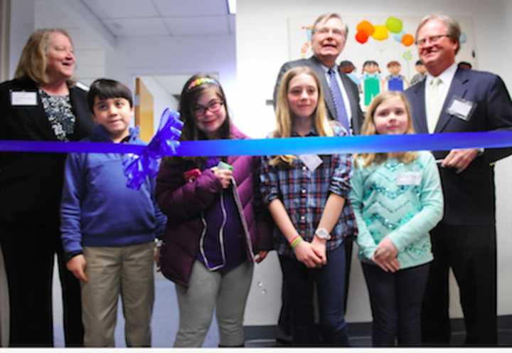 Official ribbon cutters from left, front row, Wesley Elkind, Louisa Knapp, Molly and Katie Hayes, wait for Stamford Mayor David Martin to say the word as Linda Talbert, and Dennis Perry look on.