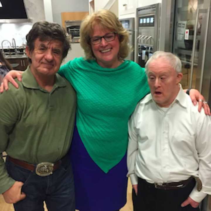 Katie Banzhaf, executive director of STAR, with Stephen Grubniak, left, and Jeff Russakoff, right, at Galaxy of Gourmets for STAR on Thursday night in Norwalk. The event benefited STAR, which helps people with developmental disabilities.