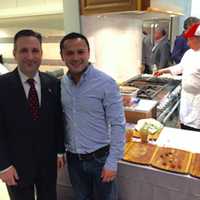 <p>State Sen. Bob Duff, left, with Marco Siguenza, owner of Washington Prime restaurant at the Galaxy of Gourmets for STAR event Thursday in Norwalk. Washington Prime employee Eleazar Moran, in back, is busy cooking the steak being served.</p>