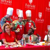 <p>Judges Donatella Arpaia, Anif McDonald and Sissy Biggers celebrate with Team Kostka at the Fairfield University student meatball competition.</p>