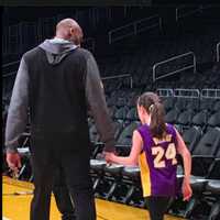 <p>Bryant walks Pellicciari up the court at the Staples Center in Los Angeles.</p>