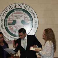 <p>Kevin Helder is sworn in as wife, Jennifer, looks on.</p>