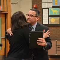 <p>Dr. Christopher Manno hugs his wife, Melissa, moments after Bedford Central&#x27;s school board appointed him as schools superintendent. School Board President Jennifer Gerken, pictured at right, looks on.</p>