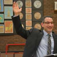 <p>Dr. Christopher Manno, who has been named Bedford Central&#x27;s new schools superintendent, address the crowd. He is pictured raising his hand while asking a question from the audience.</p>