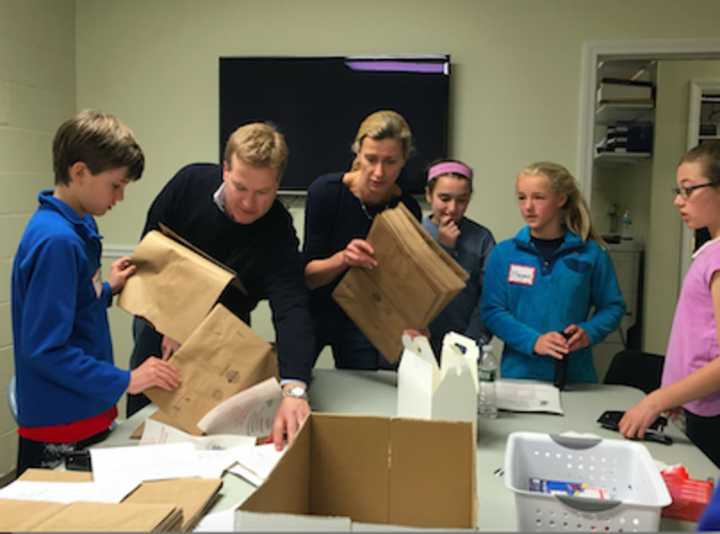 Volunteers prepping grocery bags for a U.S. Postal Service food drive at Person to Person during Kyle A. Markes Day of Service April 16.