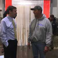 <p>Norm Bloom and his son, Jimmy, right, talk with U.S. Sen. Chris Murphy during a tour of Bloom&#x27;s Copps Island Oysters facility Thursday in Norwalk.</p>