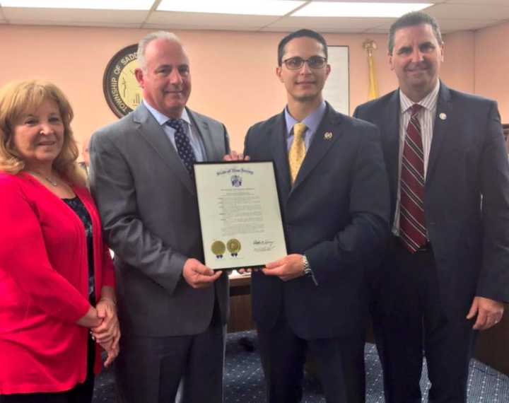 Assemblyman Joe Lagana (center right) presents a certificate to Saddle Brook Mayor Robert White (center left) to celebrate the township&#x27;s 300th anniversary.