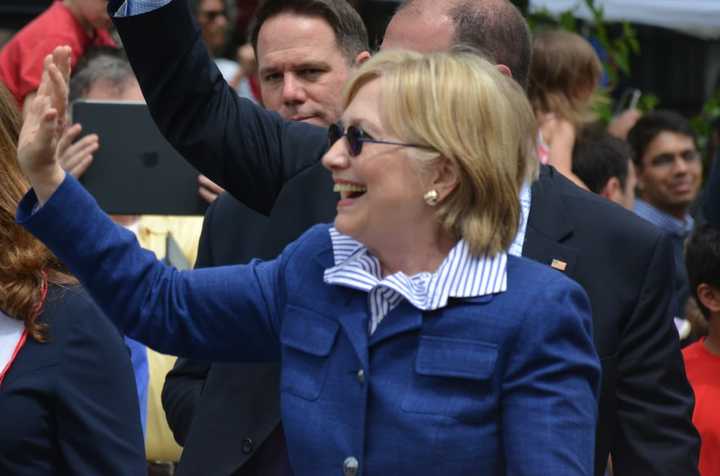 Hillary Clinton waves as she marches in the town of New Castle&#x27;s 2016 Memorial Day parade, which went through downtown Chappaqua on Sunday.