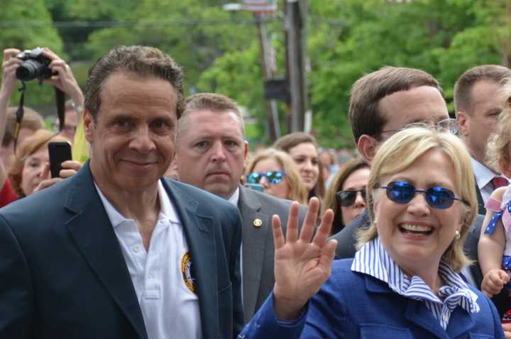 Chappaqua&#x27;s Hillary Clinton waves as she marches in New Castle&#x27;s Memorial Day parade. Gov. Andrew Cuomo, who lives in the northern side of town, is pictured at left.