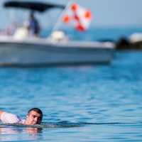 <p>A swimmer pops out of the water momentarily to take a breath during the Swim Across America Greenwich-Stamford.</p>